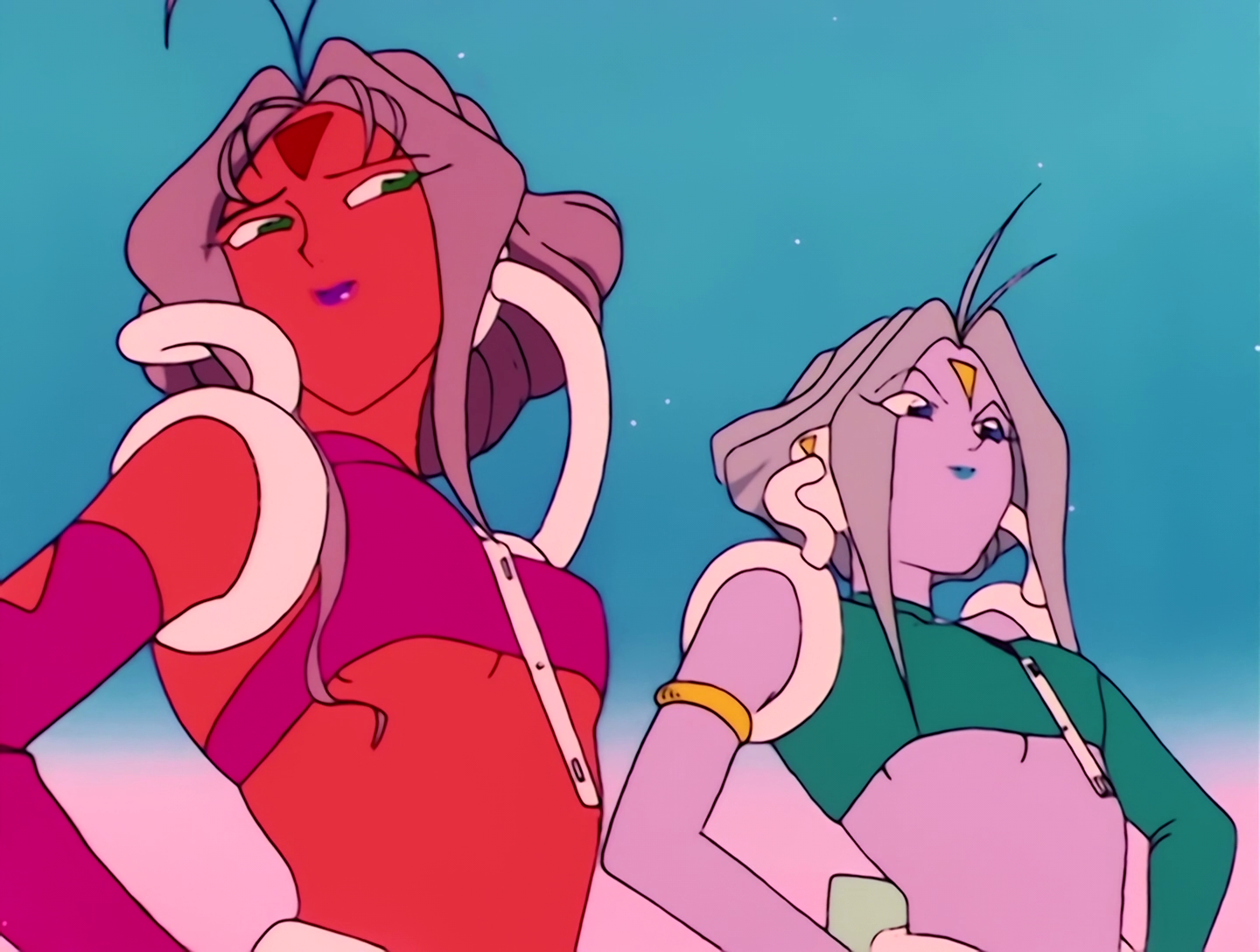 Castor and Pollux, Youma from Sailor Moon episode 21. Castor’s on the left and Pollux is on the right. Castor has orange skin, mauve hair and a magenta outfit. Pollux has pinkish-gray skin, gray skin and a green outfit. They also have tails, which you can’t see here, and when they’re getting on well, their tails are wrapped around each other. You know, like gals who are also pals.